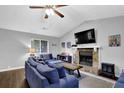 Cozy living room with a stone fireplace, vaulted ceilings, and comfortable seating area at 5461 Forest Path Ct, Stone Mountain, GA 30088
