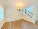 Bright dining room featuring hardwood floors, wainscoting, and a staircase to the upper level at 750 Summerstone Ln, Lawrenceville, GA 30044