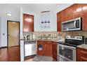 Bright kitchen with stainless steel appliances, granite counters, and wood cabinets offering a stylish and functional cooking space at 898 Oak Sw St # 3204, Atlanta, GA 30310