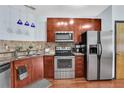Well-lit kitchen boasts stainless steel appliances, granite countertops, and elegant wood cabinets, creating a warm cooking space at 898 Oak Sw St # 3204, Atlanta, GA 30310