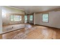 Spacious living room with hardwood floors and large windows, offering plenty of natural light and renovation potential at 1913 Flintwood Se Dr, Atlanta, GA 30316