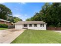 Charming single-story home with a well-manicured lawn and a driveway leading to an attached garage at 2021 Sherwood Dr Se, Marietta, GA 30062