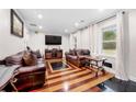 Inviting living room with hardwood floors, two couches, and an abundance of natural light at 2021 Sherwood Dr Se, Marietta, GA 30062
