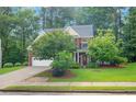 Beautiful brick home with a well-manicured lawn and mature trees providing shade and privacy at 3522 Estates Landing Nw Dr, Kennesaw, GA 30144