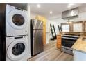 Modern kitchen equipped with stainless steel appliances, granite countertops, and exposed brick accent wall at 40 Daniel Se St # 1, Atlanta, GA 30312