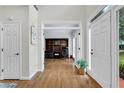 Bright foyer featuring hardwood floors, white trim, and a view into the office, offering a spacious entry at 209 Breckenridge Ct, Canton, GA 30115