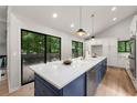 Bright open kitchen featuring a large island with bar seating and a sliding glass door to the deck at 3430 Rocky Springs Ct, Marietta, GA 30062
