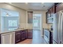 Modern kitchen with granite countertops, stainless steel appliances, and dark wood cabinets at 2317 Church Street, Hampton, GA 30228