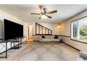 Spacious living room with a large window, ceiling fan, and open access to the split level in the home at 319 Hill Crest Cir, Woodstock, GA 30188
