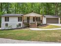 Beautifully renovated house featuring a charming front porch, new paint, and manicured landscaping at 3455 Broxton Mill Way, Snellville, GA 30039
