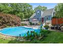 Backyard in-ground pool with lounge chairs, stone patio and greenery at 64 Edwin Nw, Atlanta, GA 30318
