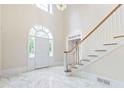 Staircase and entry way, with a marble floor and large entry window at 320 Yellowroot Ln, Sandy Springs, GA 30350