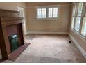 A cozy living room with a fireplace and large windows, creating a warm and inviting space at 389 Dargan Sw Pl, Atlanta, GA 30310
