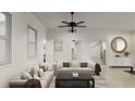 Bright living room featuring a large sectional sofa, modern ceiling fan, and neutral decor at 1161 Dahlonega Hwy # 3, Cumming, GA 30040