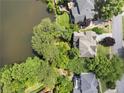 Aerial shot of a beautiful home with backyard lake access, surrounded by lush greenery at 3260 Kingshouse Commons, Johns Creek, GA 30022