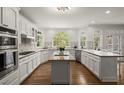 Spacious kitchen with white cabinetry, stainless steel appliances, and a large center island at 3260 Kingshouse Commons, Johns Creek, GA 30022