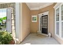 Inviting front porch with decorative columns and front door, creating a warm welcome to this lovely home at 4535 Vanadium Bnd, Cumming, GA 30040