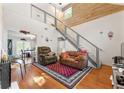 The living room features a soaring ceiling, unique staircase, wood wall accents and hardwood floors at 5150 Wheat Ne St, Covington, GA 30014