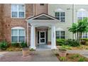 Building entrance with columns and landscaping at 1965 Nocturne Dr # 1306A, Alpharetta, GA 30009