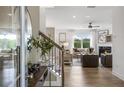 Bright and airy living room with hardwood floors, a fireplace, and large windows overlooking the backyard at 317 Foxglove Way, Mcdonough, GA 30253
