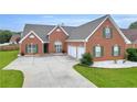A classic brick home featuring an attached two-car garage at 502 Stoneland Pl, Lawrenceville, GA 30046