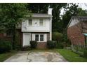 Charming two-story home with a brick front and a cracked driveway at 936 Glynn Oaks Dr, Clarkston, GA 30021