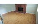 Bright living room featuring hardwood floors and a cozy brick fireplace at 936 Glynn Oaks Dr, Clarkston, GA 30021