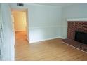 Open living room with hardwood floors and a brick fireplace ready for cozy evenings at 936 Glynn Oaks Dr, Clarkston, GA 30021