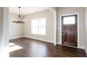 Bright entryway features hardwood flooring and a stylish chandelier at 269 Highway 11, Social Circle, GA 30025