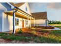 Inviting home featuring a covered porch and lush landscaping at 269 Highway 11, Social Circle, GA 30025