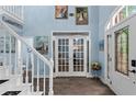 Bright foyer with a beautiful front door and staircase at 4365 Wicklow Ct, Suwanee, GA 30024