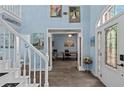Bright foyer leading to an office space and a staircase at 4365 Wicklow Ct, Suwanee, GA 30024