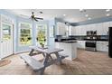 The bright kitchen features stainless steel appliances, white cabinets and plenty of counter space at 4365 Wicklow Ct, Suwanee, GA 30024