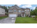 Beautiful two-story brick home featuring a two-car garage and lush green lawn at 4511 Bridgeway Rd, Atlanta, GA 30331