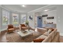 Staged living room with hardwood floors, stylish furniture, and view of the front door at 4511 Bridgeway Rd, Atlanta, GA 30331