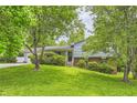 Lovely home with blue siding, lush green lawn, mature trees, and inviting front entrance at 3551 Cindy Way, Rex, GA 30273