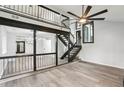 Bright living room featuring modern gray flooring and unique staircase and lighting at 6700 Knollwood Cir, Douglasville, GA 30135