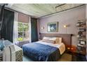 Serene bedroom featuring a large window with natural light and neutral decor at 800 Peachtree Ne St # 1014, Atlanta, GA 30308