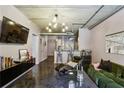 Stylish living area with concrete floors, exposed ductwork, and comfortable modern furnishings at 800 Peachtree Ne St # 1014, Atlanta, GA 30308
