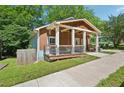 Cozy home featuring a quaint front porch with a swing and updated railings at 999 Smith Sw St, Atlanta, GA 30310