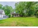 Charming single-story home with a welcoming front porch and a well-manicured lawn at 5310 Arrowind Nw Rd, Lilburn, GA 30047
