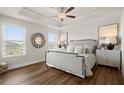 Elegant main bedroom with tray ceilings, wood floors, and bright windows at 934 Elwood St, Dacula, GA 30019