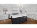 Bright kitchen boasts white cabinets, stainless steel appliances, black island, and hardwood floors at 1415 Dalewood Ne Dr, Atlanta, GA 30329