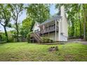 Exterior shot of the house, featuring a porch, stairs, and well-maintained landscaping at 3021 Mills Ridge Dr, Canton, GA 30114