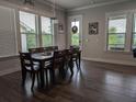 Inviting dining room with hardwood floors, large windows, and a stylish chandelier over a table with seating for eight at 322 Woodridge Pass, Canton, GA 30114