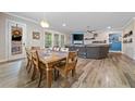 Bright, open-concept living space featuring hardwood floors, fireplace, and sliding glass doors to the backyard at 322 Woodridge Pass, Canton, GA 30114