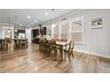 Open-concept living space showcasing wood floors, bar stool seating and seamless transition to the kitchen at 322 Woodridge Pass, Canton, GA 30114
