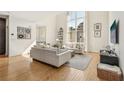 Bright living room boasts high ceilings, large windows, hardwood floors, and elegant, modern furniture at 1290 Nervi Nw Mews, Atlanta, GA 30318