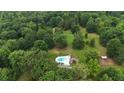 Stunning aerial view of a private backyard oasis with a sparkling in-ground pool at 400 Simpson Ne Rd, White, GA 30184