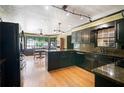 Elegant kitchen with dark cabinetry, granite countertops, and stainless steel appliances at 400 Simpson Ne Rd, White, GA 30184